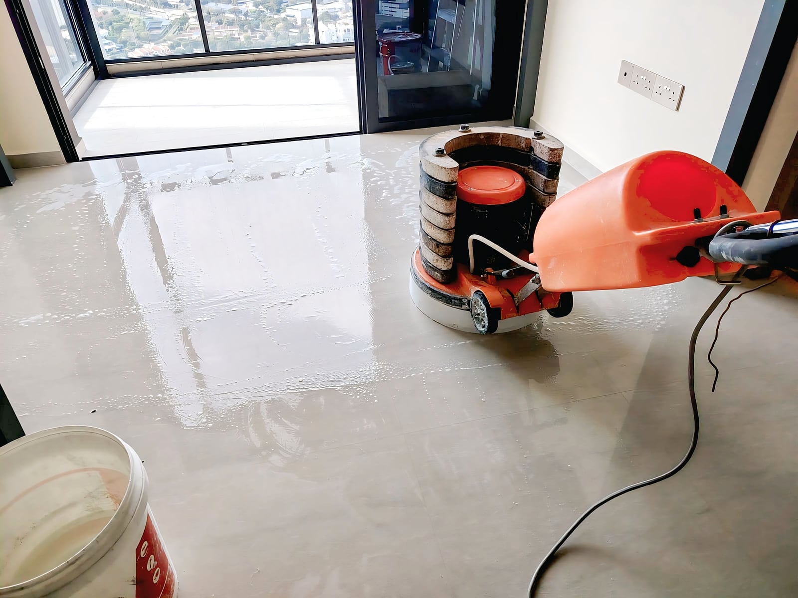 Floor polishing machine working across a prepared floor surface
