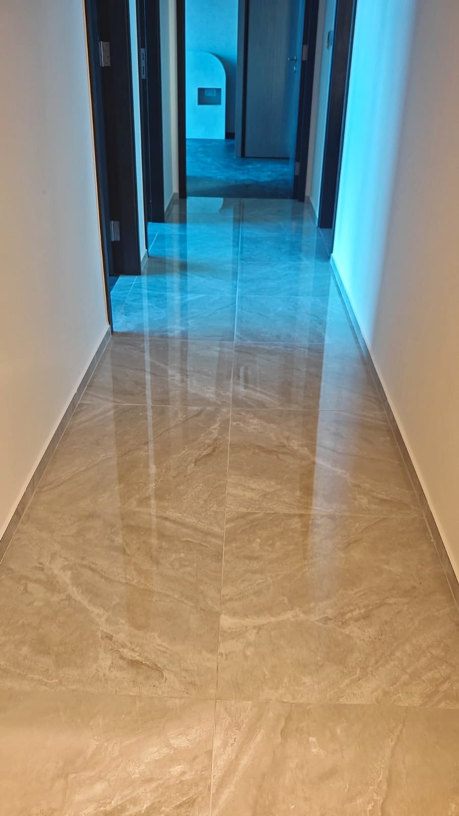 Polished hallway floor with a restored reflective finish