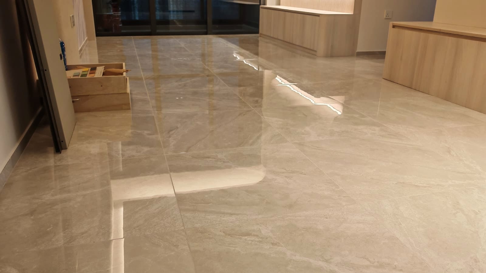 Restored living room floor with a reflective finish by Pro Surface Works