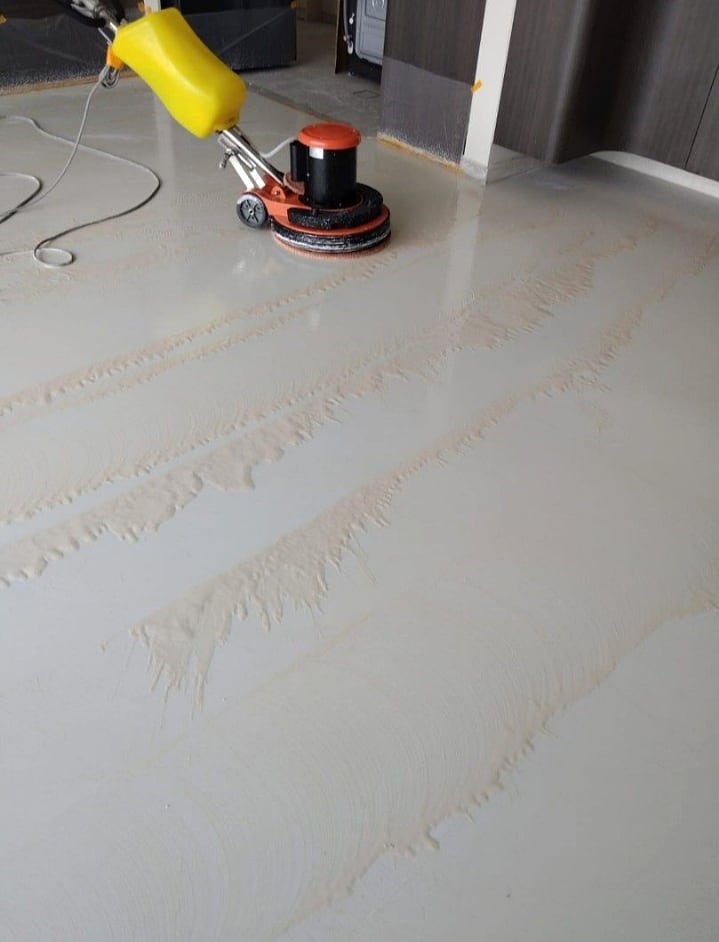 Machine cleaning over stone floor joints before grouting finish