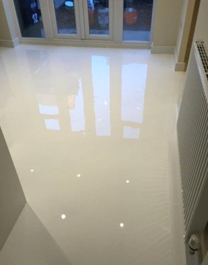 Waterproof epoxy grout finish across a bright tiled room