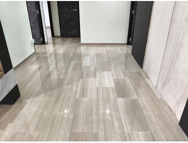 Completed marble restoration with a polished hallway finish