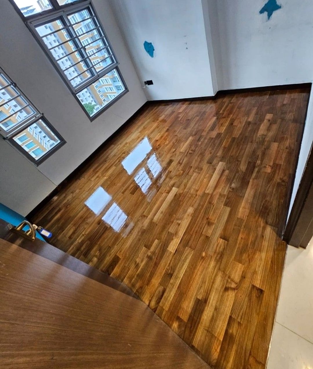 Completed parquet room polish with reflective wood flooring