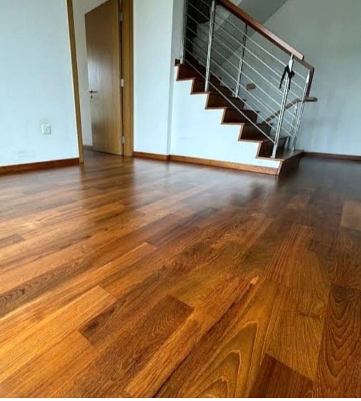 Finished wood flooring next to a staircase after installation