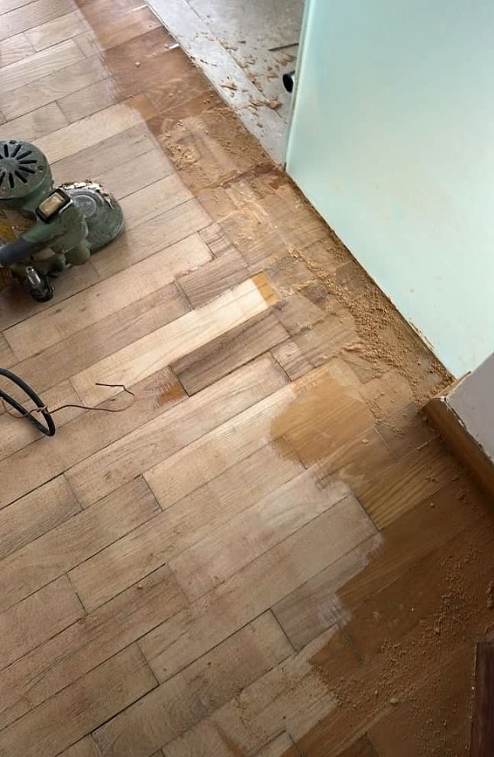Edge sanding and old varnish removal near a wall line