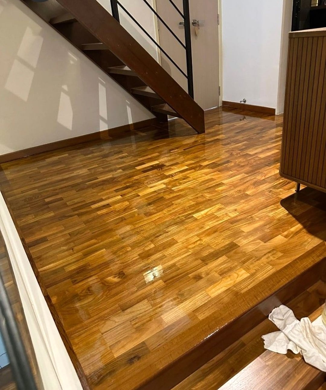 Polished timber floor with skirting and stair edge details