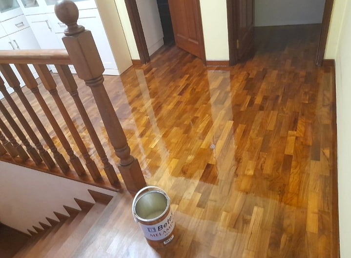 Timber floor varnish application near a staircase landing