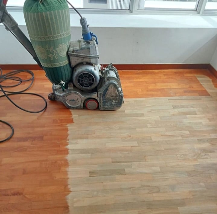 Wood floor showing sanding progress before new varnish