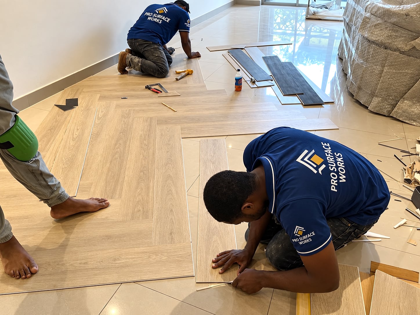 Light oak vinyl flooring installation in progress by Pro Surface Works